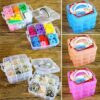 Transparent jewelry storage box is used to store rubber bands and earrings. It is presented in blue, orange, and pink color.
