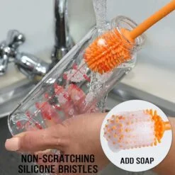 A person is washing a glass bottle with silicone bottle brush cleaner.