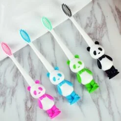 panda toothbrush is present in pink, blue, green, and black color