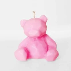 Pink color teddy bear candle for cake is shown.