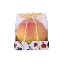 Peach shaped candle is presented in transparent packet with yellow color ribbons on it.