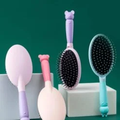 Cushion paddle hair brush is displayed in 4 different colors.