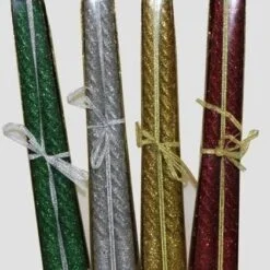 Glitter candle is presented in green, silver, yellow, and red color