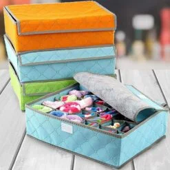 Closet organizer for socks and underwear is presented in sky blue, orange, and green color.