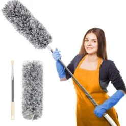 Extendable feather duster is being held by a woman who is cleaning the house.