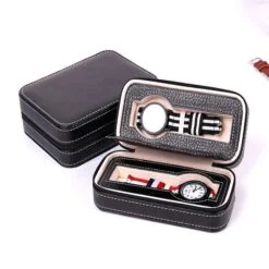 Two watches are organized in a black color watch storage case