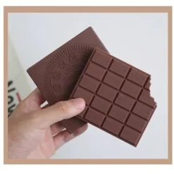 A person is holding a chocolate note book