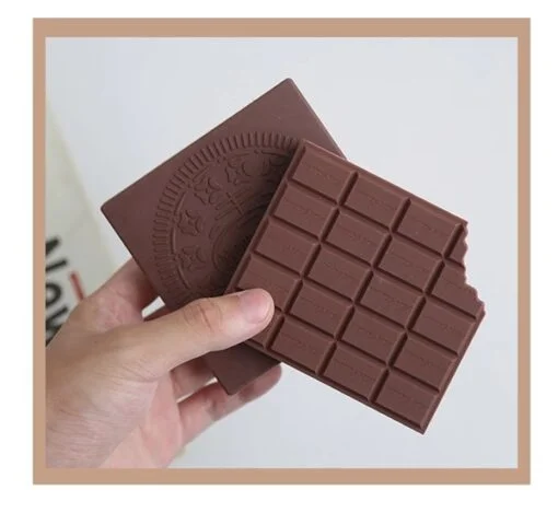 A person is holding a chocolate note book.