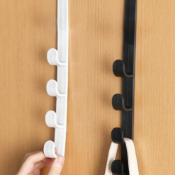 Woman is installing white and black color over the door metal hanger.