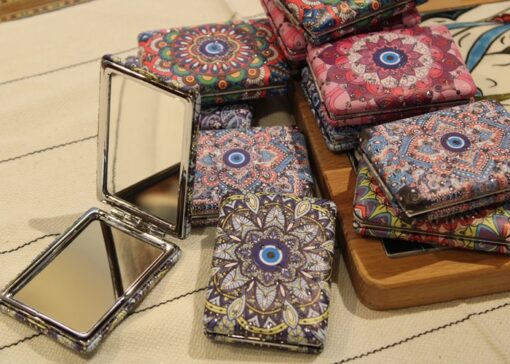 Travel pocket mirror is shown in different designs and patterns.