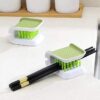 Double sided green color tool is being used as a chopstick cleaner.