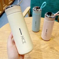 400ml high quality glass water bottle with nice print is presented in cream, pink, and blue color.