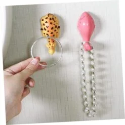Animal shape self adhesive sticky hook is shown in 2 different colors and patterns.