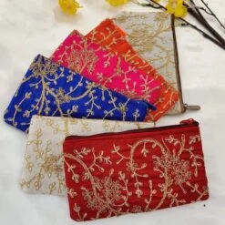 Angoori design embroidered pouch shown in red, white, blue, pink, and orange color.