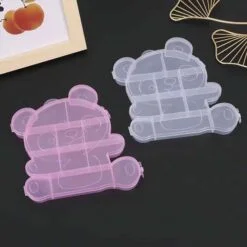 Plastic earring box is shown in purple and white color.