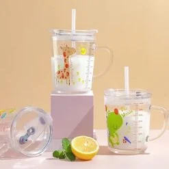 Glass mug with lid and straw is presented in 3 different prints on a table besides half lemon and couple of mint leaves.