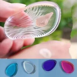 A girl is squeezing transparent silicone makeup sponge to show its flexibility and quality. At the bottom, silicone makeup sponge is presented in 4 different colors