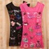 Dress shape hanging jewelry bag organizer is shown in pink and black color.