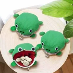 Frog shape cute coin purse is placed on a table.