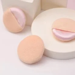 Face powder pad are pictured from different angles.