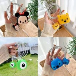 Woman is holding 4 different types of cartoon iphone charger protector.