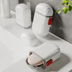 White color travel soap box is placed on a washbasin
