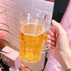 Woman is holding artificial beer glass.