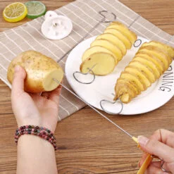 Woman is making tornado potatoes with the help of spiral fry potato cutter.