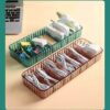 Cable organizer box is presented in brown and green color filled with different wires and cables.