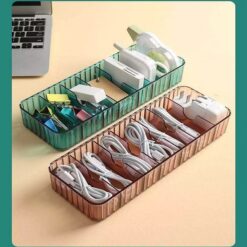 Cable organizer box is presented in brown and green color filled with different wires and cables.