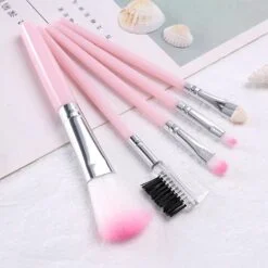 White and pink color plastic makeup brush set.