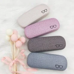 Fabric sunglasses case displayed in grey, violet, dark grey, and blue color
