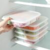 5 Compartment food containers are placed on one another in refrigerator.