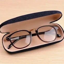 Glasses are kept in a navy blue color denim glasses case.