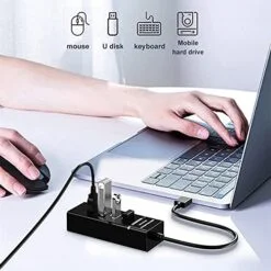 Man is working on Laptop and 4 port usb is connected.
