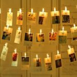 A photo wall illuminated by the warm glow of the LED string lights, creating a cozy and inviting ambiance.