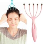 A person using a five-claw head massager on their scalp to relieve stress and tension. An image depicting a person using the five-claw head massager on their scalp to promote relaxation and relieve stress.