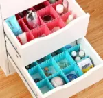 This image demonstrates the practical use of the dividers in a dresser drawer, showcasing how they effectively organize clothing items.