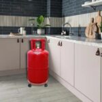 The gas cylinder trolley securely holding a gas cylinder in place, showcasing its stability and safety features.