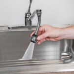 Turbo Flex Sprayer in Use A Turbo Flex 360 Faucet Sprayer attached to a kitchen faucet, spraying a powerful stream of water into a dirty sink.