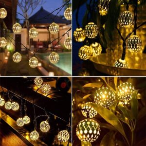 A strand of Metal Ball LED Light draped across a patio, creating a warm and inviting ambiance. The string lights are strung between two poles.