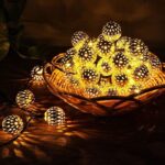 Metal Ball LED Diwali Lights A strand of Metal Ball LED Light with 20 spherical metal bulbs, illuminated and casting a warm white glow. The string light is draped across a dark background.