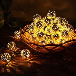 Metal Ball LED Diwali Lights A strand of Metal Ball LED Light with 20 spherical metal bulbs, illuminated and casting a warm white glow. The string light is draped across a dark background.