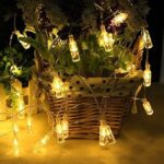 Whimsical Ambiance: 16-LED Mini Glass Bottle String Lights for Fairytale Decor A strand of 16-LED Mini Glass Bottle String Light illuminated, showcasing a cascade of miniature glass bottles glowing with a warm white light. Better quality and price compare to amazon.