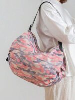 Convenient Storage: Reusable Shopping Bag Folds Compactly Close-up view of the Reusable Folding Shopping Bag in its compact, folded state. It's placed inside a purse, highlighting its portability and easy storage.