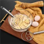 Stainless Steel Dough Whisk Mixer A person using the dough whisk mixer to incorporate ingredients in a mixing bowl.