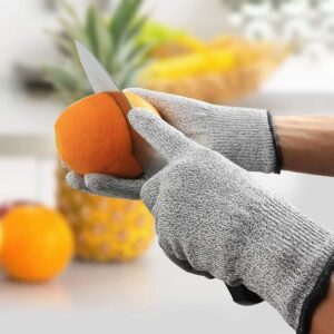 A person chopping vegetables on the chopping board, using one of the knives from the set. (