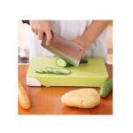 A person chopping vegetables on the chopping board, using one of the knives from the set. (