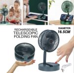 A person holding a compact, unfolded USB telescopic folding fan, showcasing its portability and adjustable design.