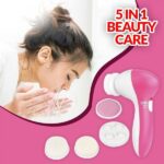 A person using the 5-in-1 Beauty Care Massager with the exfoliating brush attachment on their face.